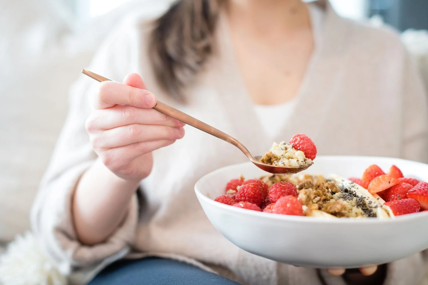 a woman eating out of a bowl